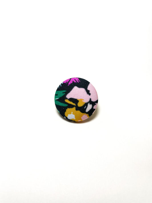 Handmade black floral fabric covered lapel pin.