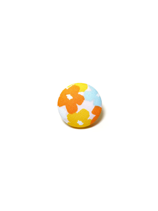 Handmade colorful floral fabric covered lapel pin.