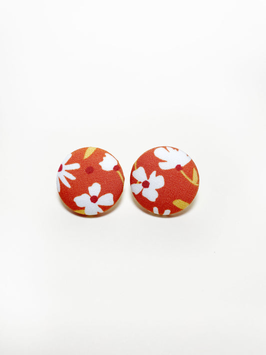 Handmade rust colored floral fabric covered post earrings.