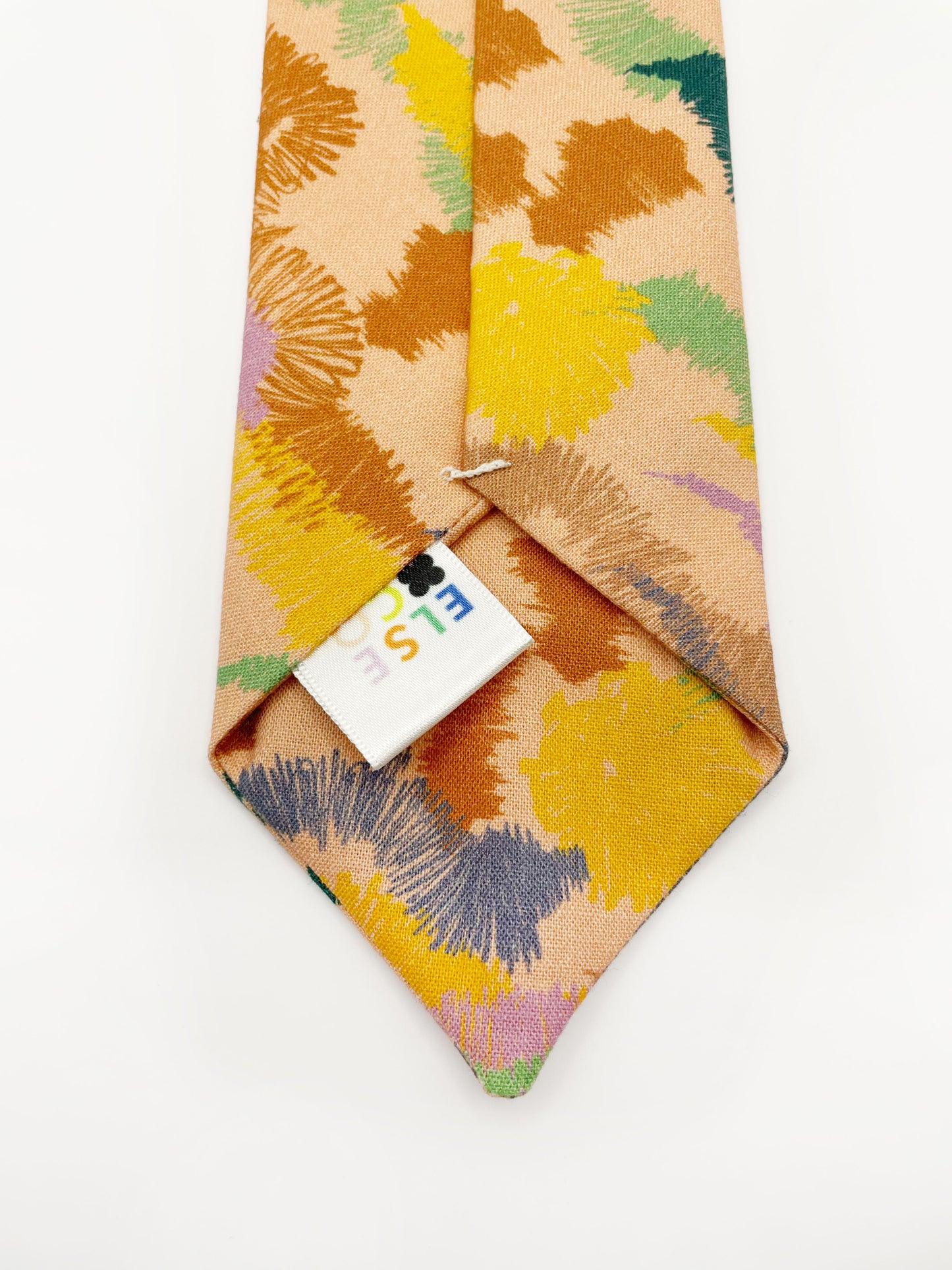 A necktie crafted from high-quality cotton with an abstract design inspired by the rolling hills and earthy tones of the desert.