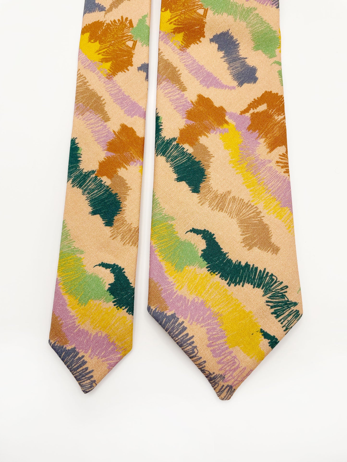 A necktie crafted from high-quality cotton with an abstract design inspired by the rolling hills and earthy tones of the desert.
