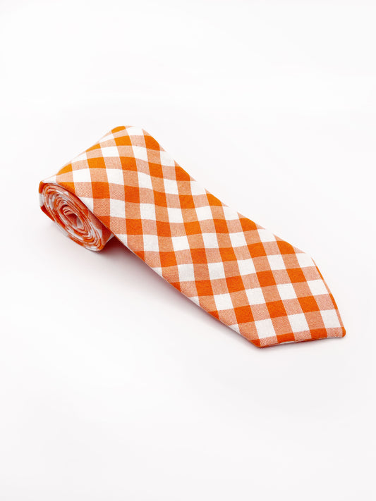 A cotton necktie with an orange and white gingham plaid print.