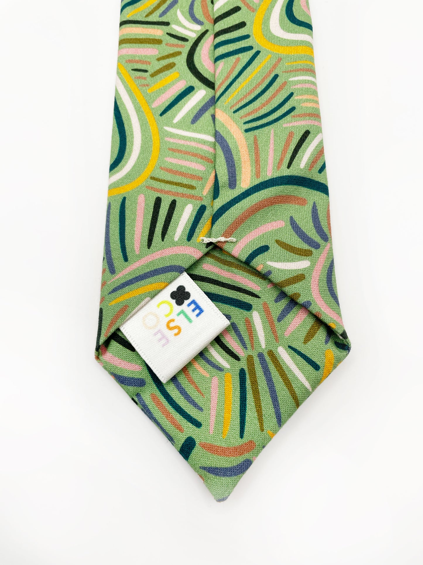 A necktie made from high-quality cotton with an abstract design inspired by desert rain patterns.