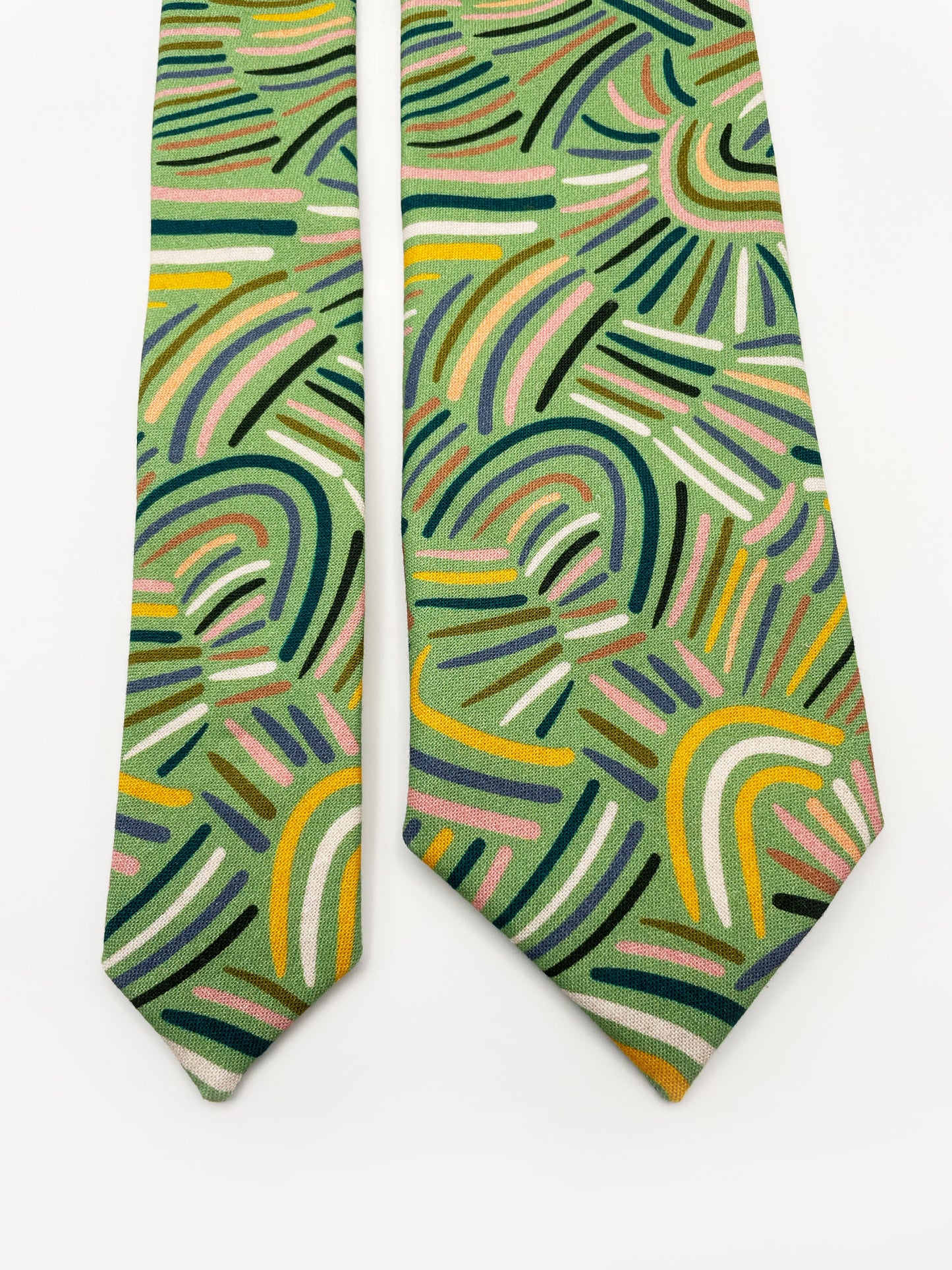 A necktie made from high-quality cotton with an abstract design inspired by desert rain patterns.