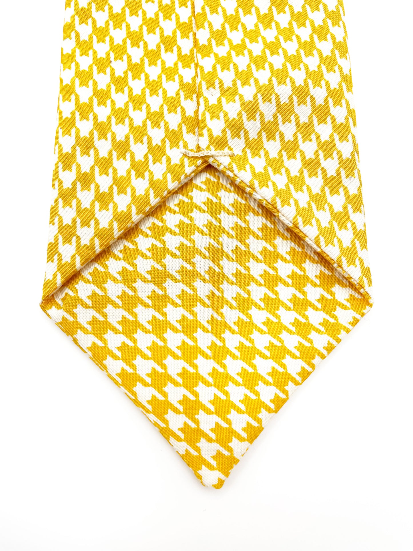 A handmade yellow houndstooth necktie.