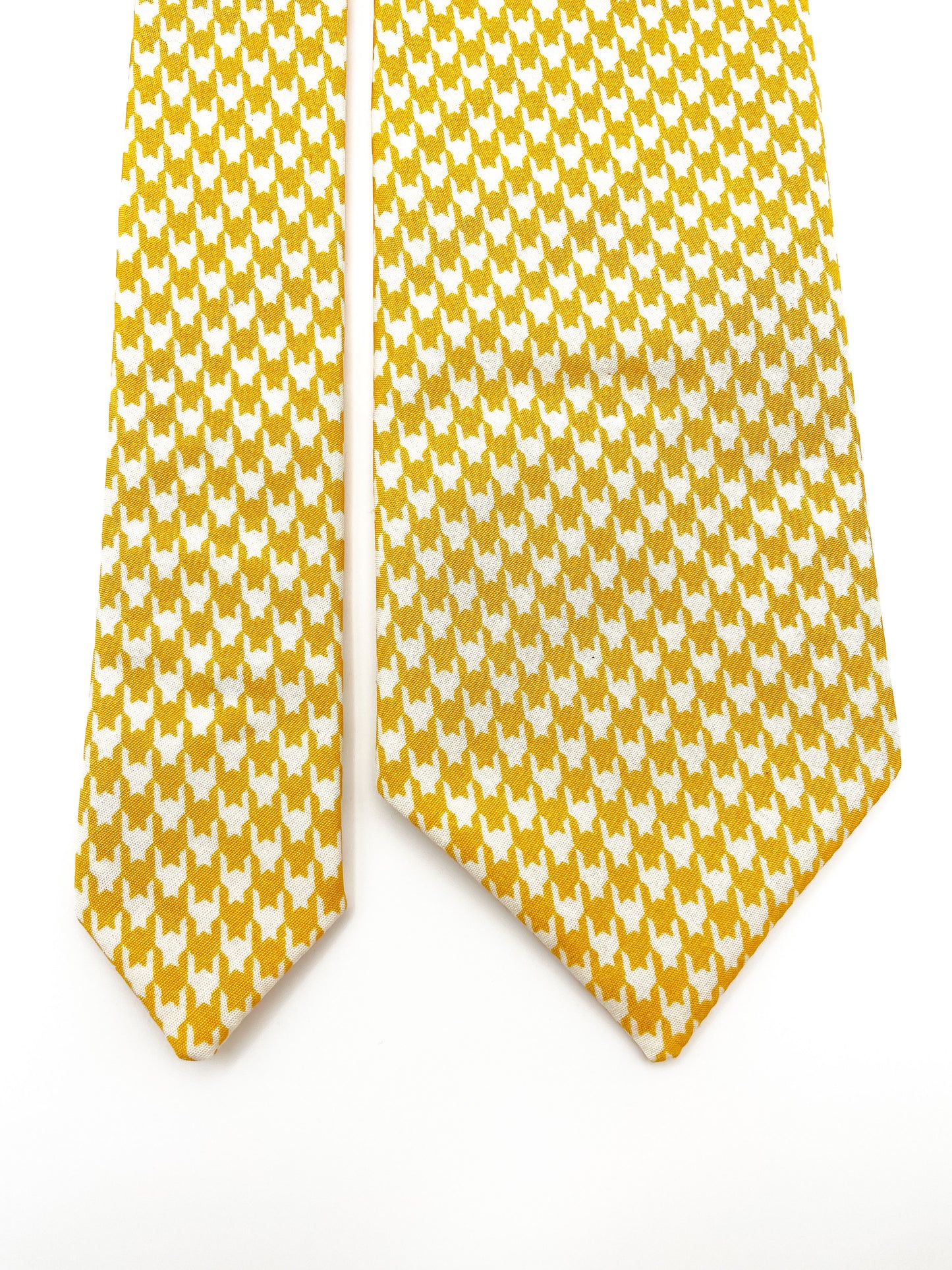 A handmade yellow houndstooth necktie.