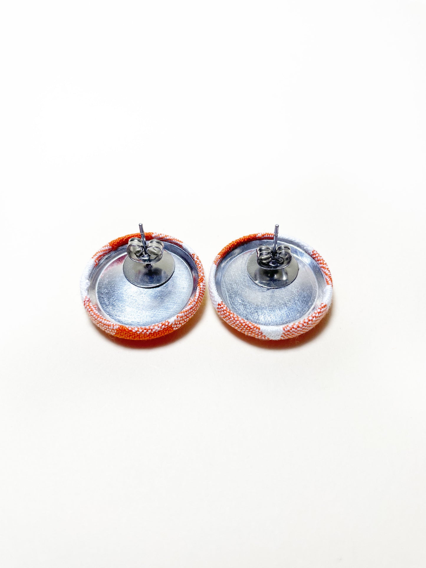 Handmade orange gingham plaid fabric covered post earrings. Each earring has a butterfly push back.