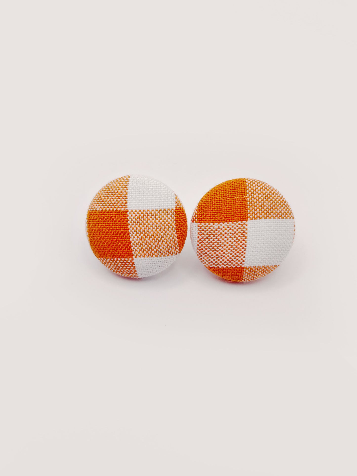 Handmade orange gingham plaid fabric covered post earrings.