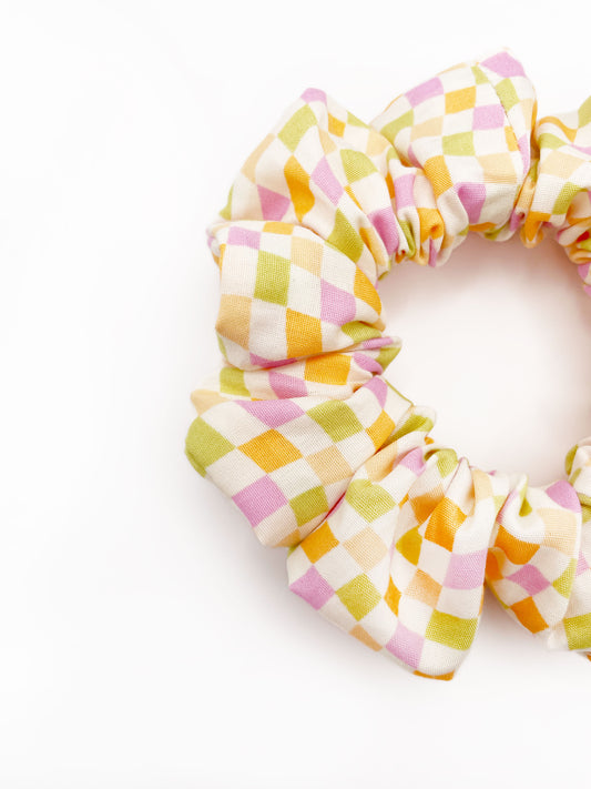 A handmade scrunchie with a pastel checkered print.