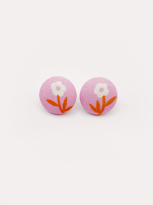 Handmade pink fabric-covered earrings with orange-stemmed flowers.
