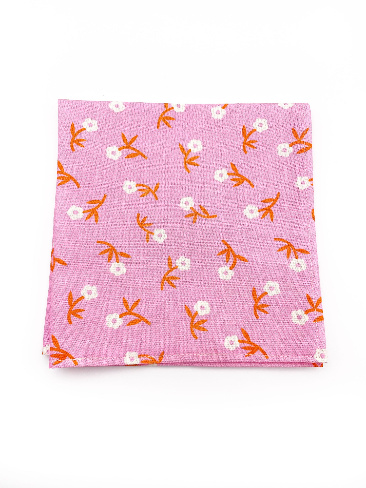 A cheerful pink pocket square with orange-stemmed flowers.