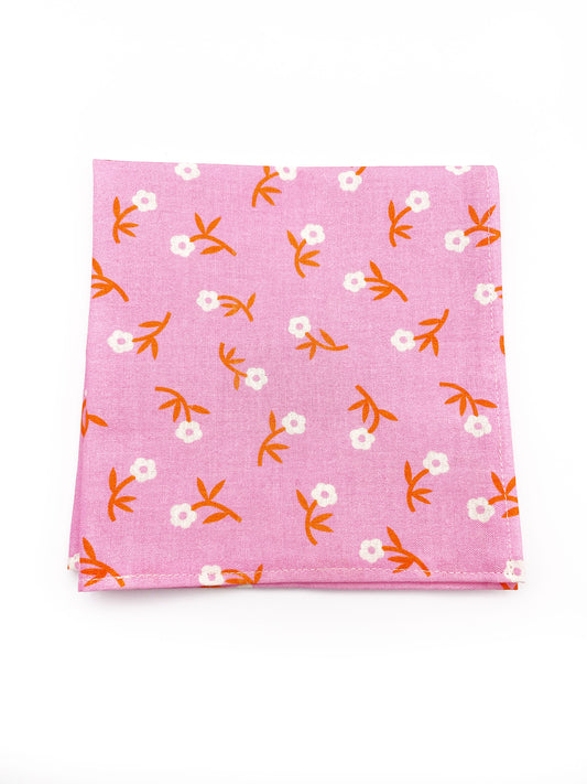 A cheerful pink pocket square with orange-stemmed flowers.