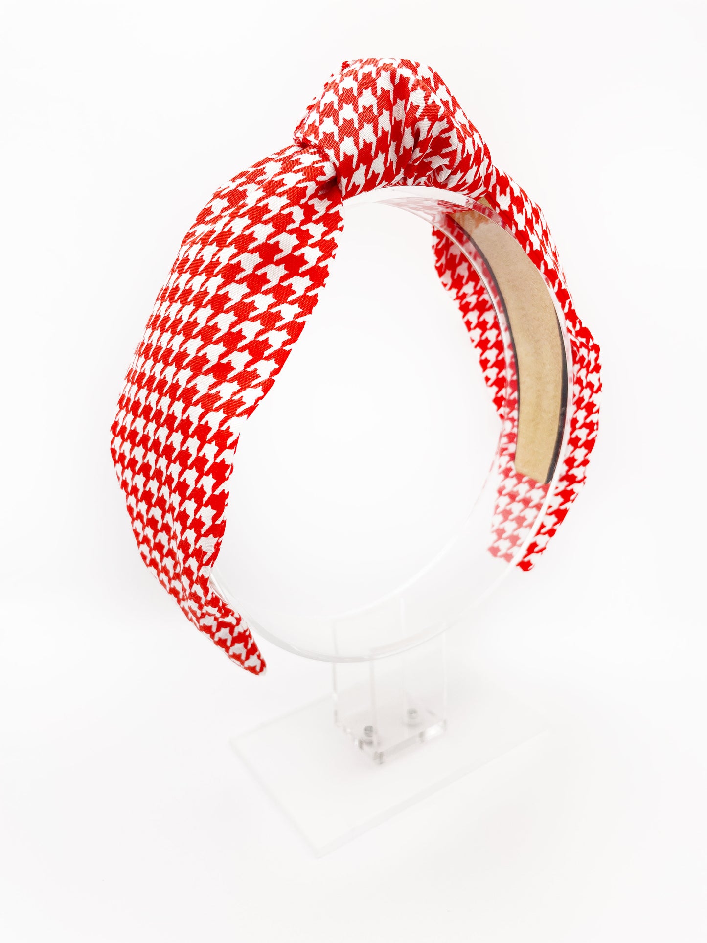 A handmade red houndstooth knotted headband.