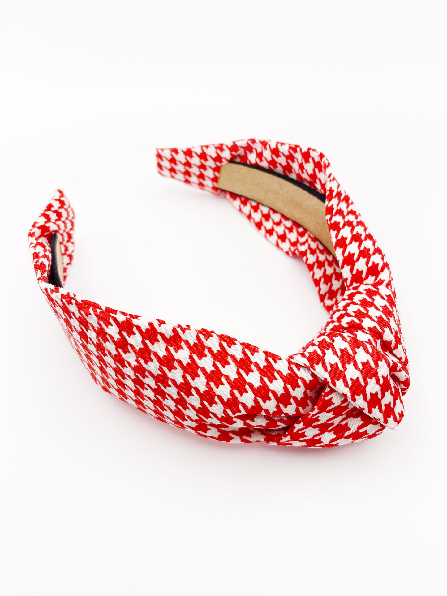 A handmade red houndstooth knotted headband.
