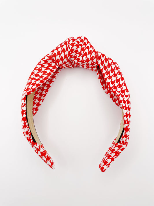 A handmade red houndstooth knotted headband.