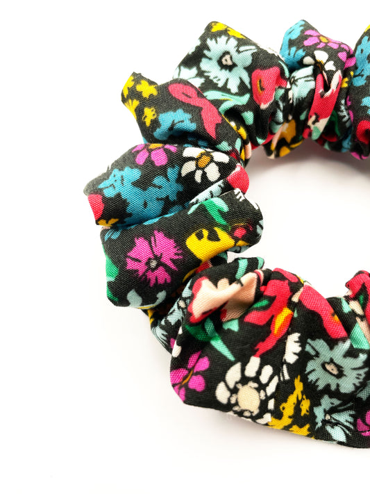 Closeup of a handmade scrunchie with vibrant flowers.