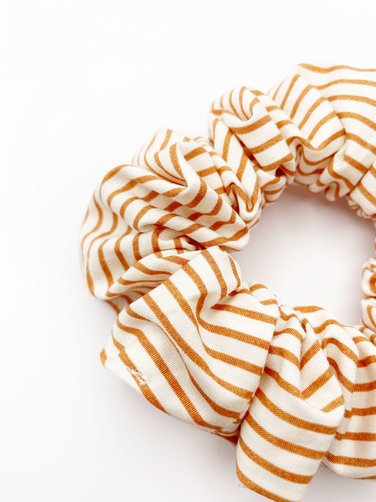 A handmade copper striped boho scrunchie.