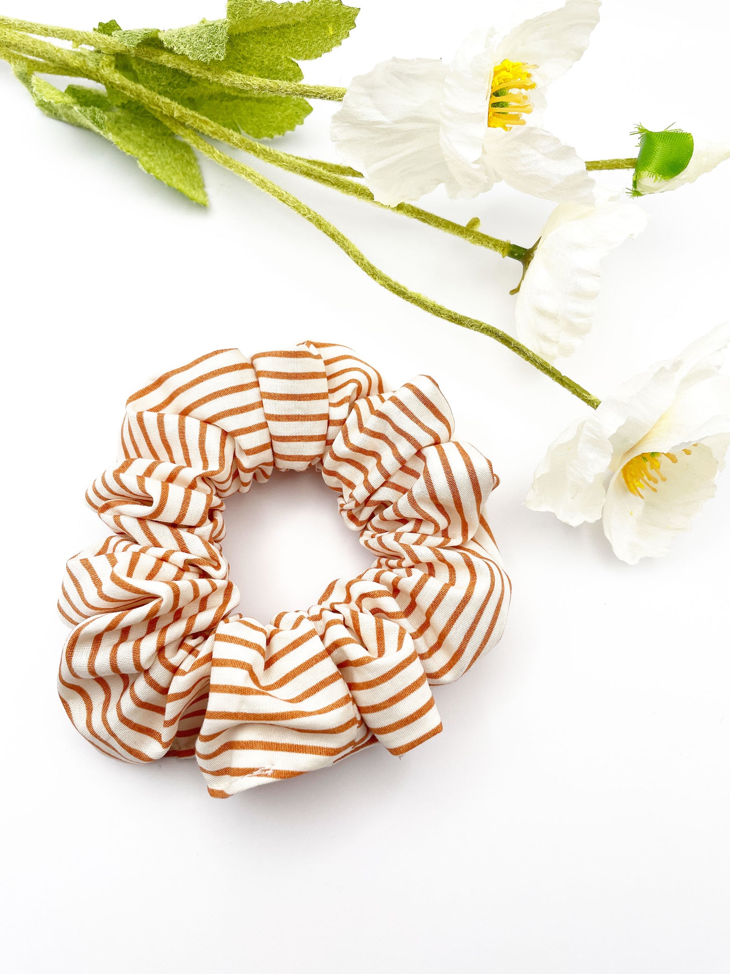 A handmade copper striped boho scrunchie.