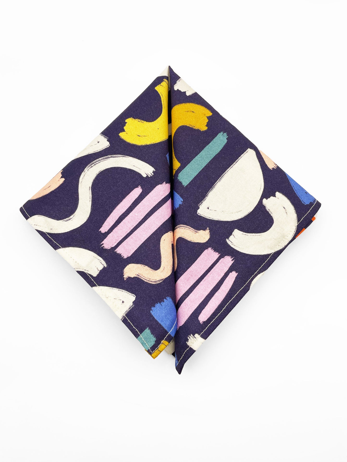 A cotton handmade pocket square with a colorful abstract print featuring various doodles.