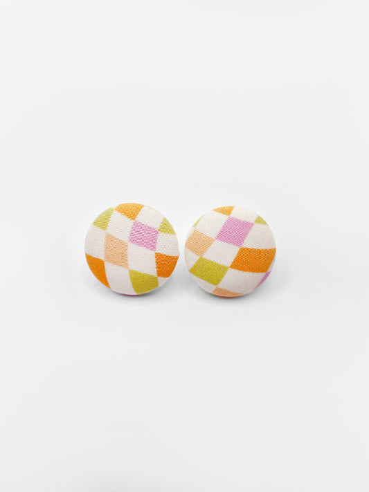 Handmade fabric earrings with a pastel checkered print.