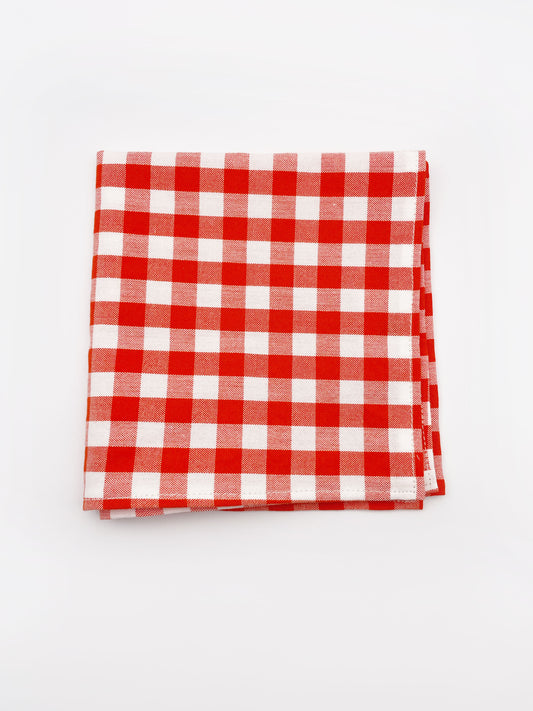 A cotton handmade pocket square with a red gingham plaid print.