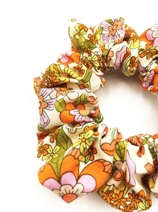A handmade retro floral scrunchie.