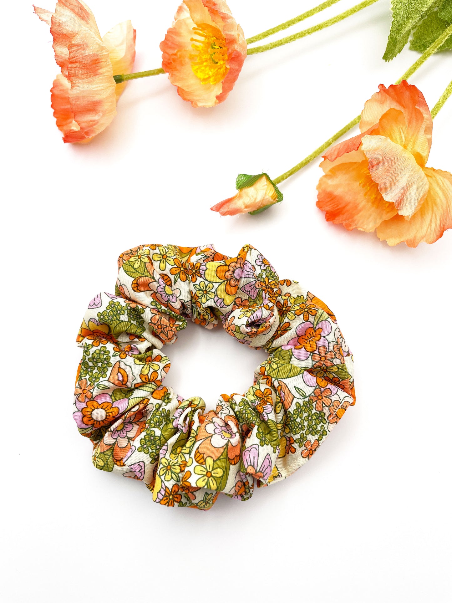 A handmade retro floral scrunchie.