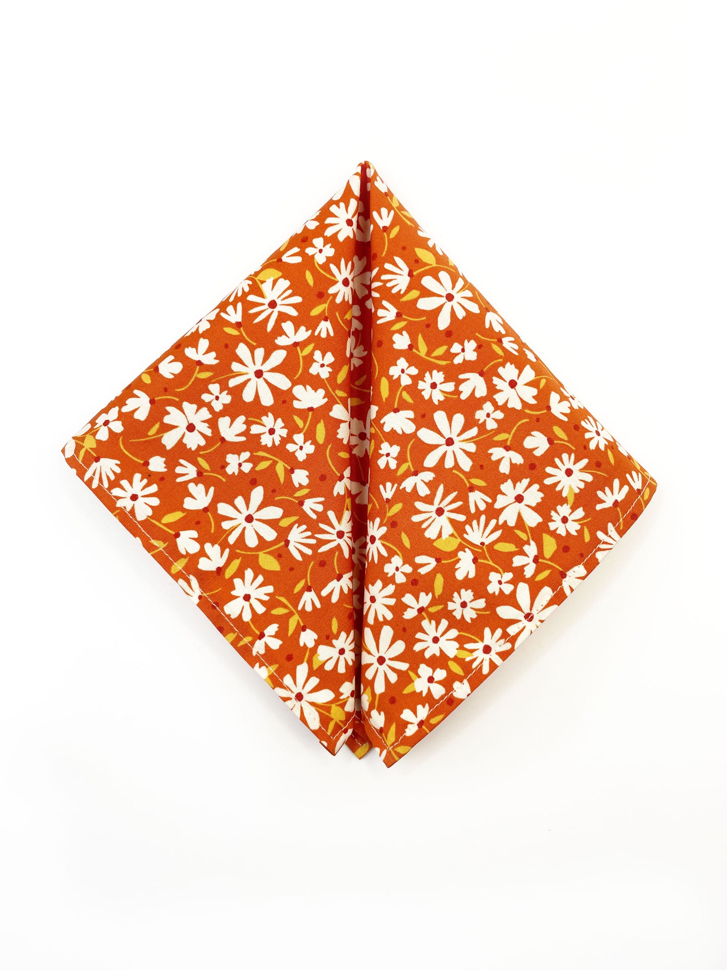 A rust brown floral pocket square with white flowers, showcasing shades of earthy browns and pops of warm peach and blush pink. 