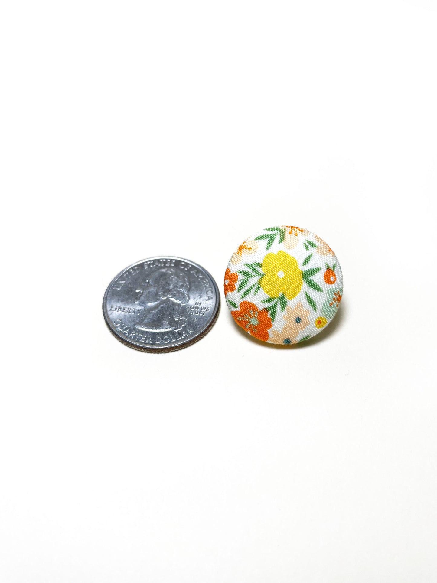 Handmade ditsy floral fabric covered lapel pin. The earrings are 0.875 inches, roughly the same size as a quarter.