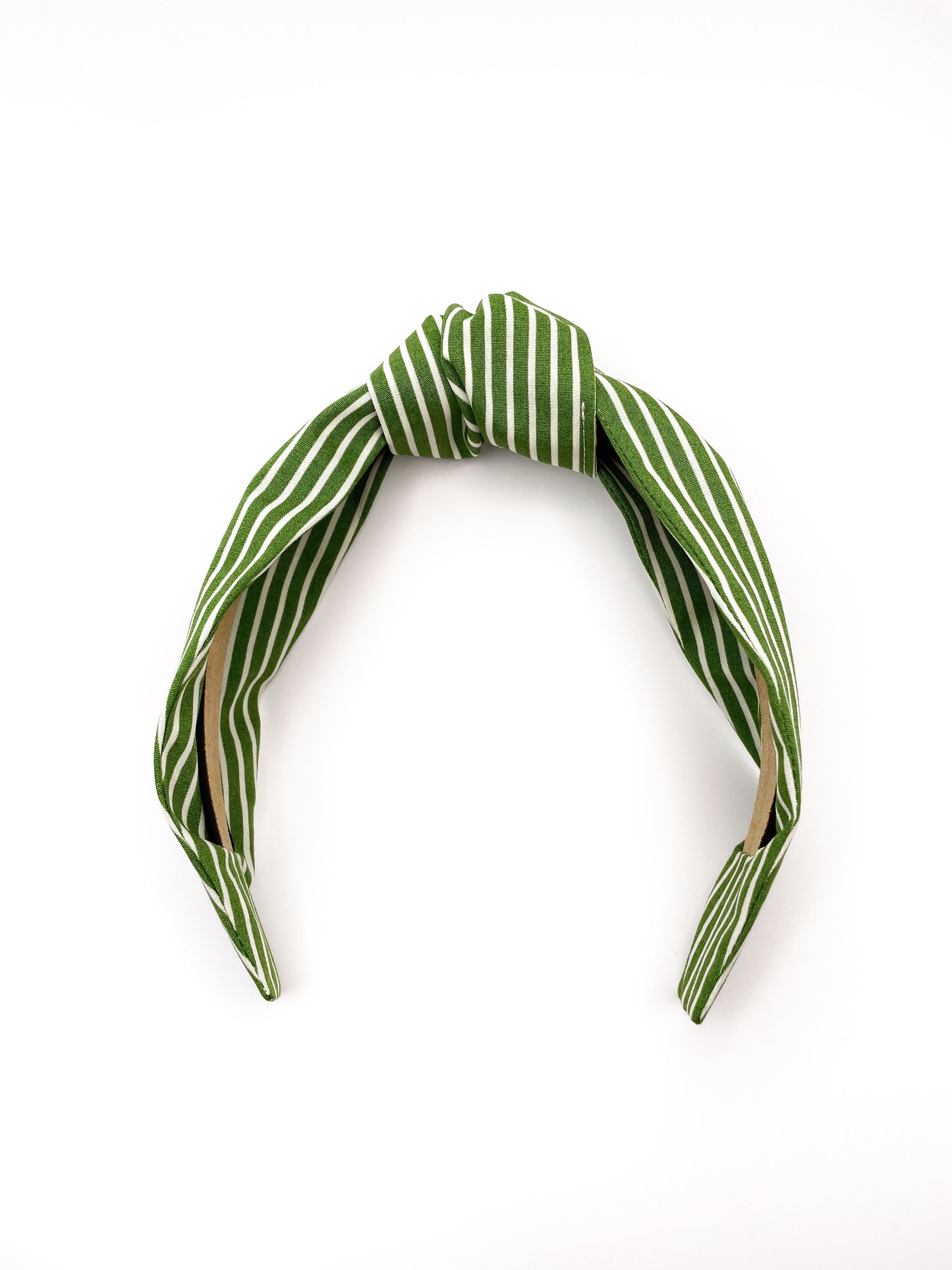 A handmade knotted headband featuring a white striped print against a moss green background.