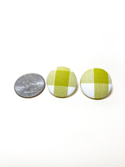 Handmade green gingham plaid fabric covered post earrings. The earrings are 0.875 inches, roughly the same size as a quarter.