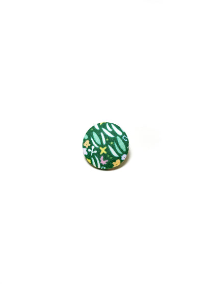 Handmade green floral fabric covered lapel pin.