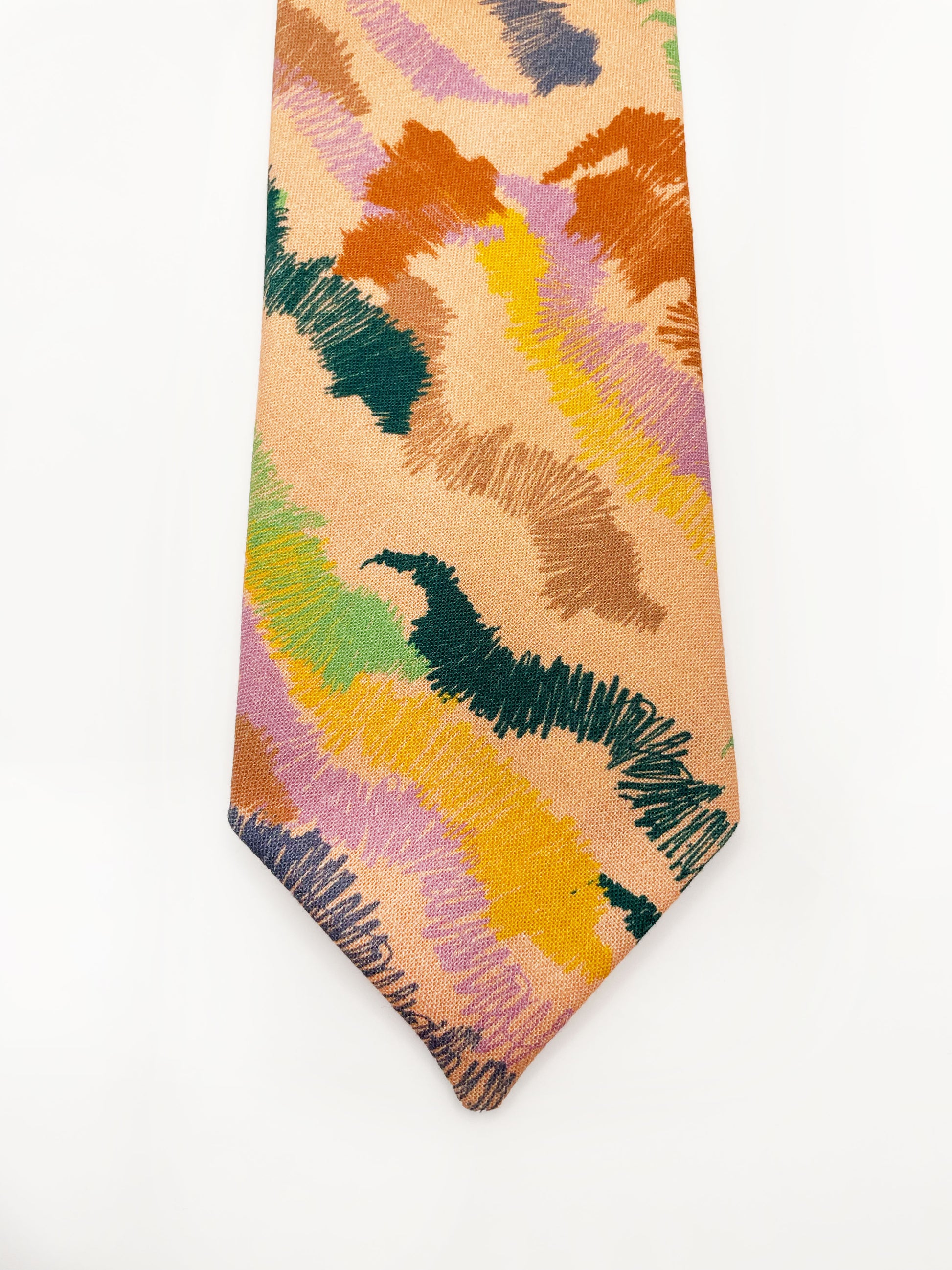 A necktie crafted from high-quality cotton with an abstract design inspired by the rolling hills and earthy tones of the desert. 