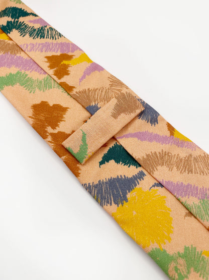 A necktie crafted from high-quality cotton with an abstract design inspired by the rolling hills and earthy tones of the desert. 