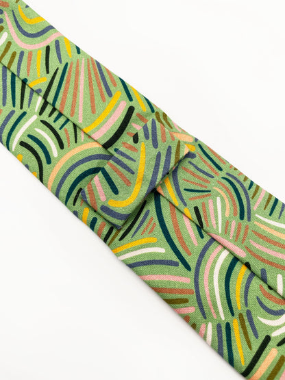 A necktie made from high-quality cotton with an abstract design inspired by desert rain patterns. 