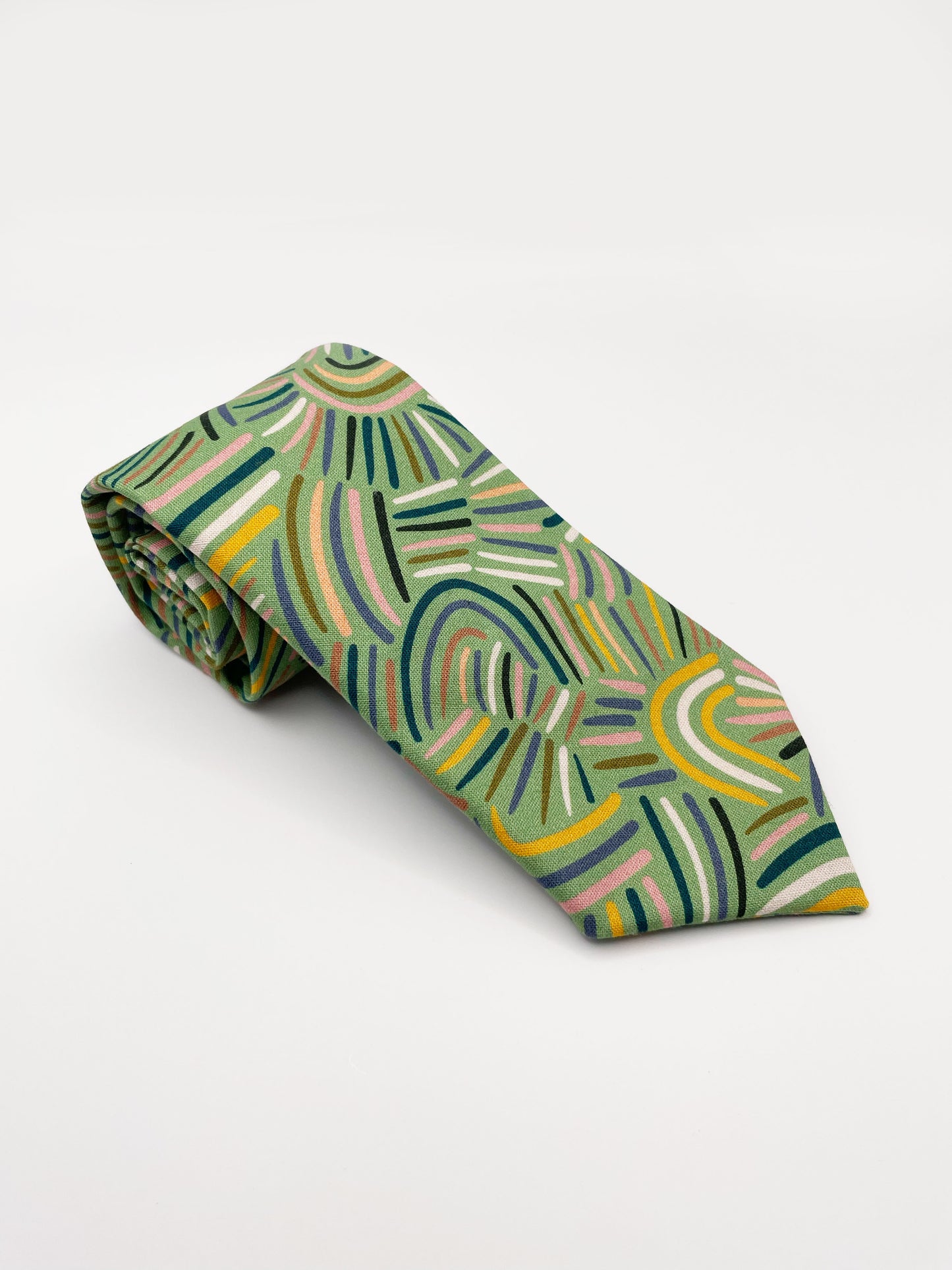 A necktie made from high-quality cotton with an abstract design inspired by desert rain patterns. 