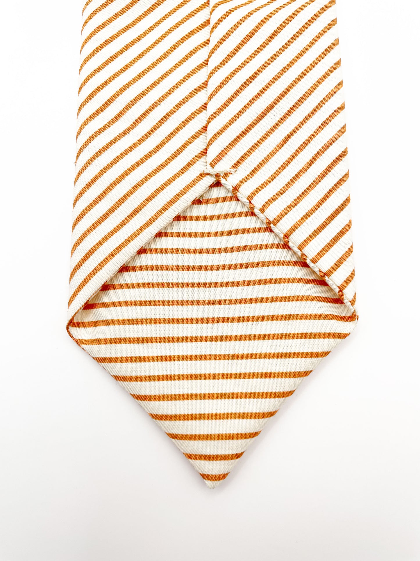 A handmade copper striped boho necktie.