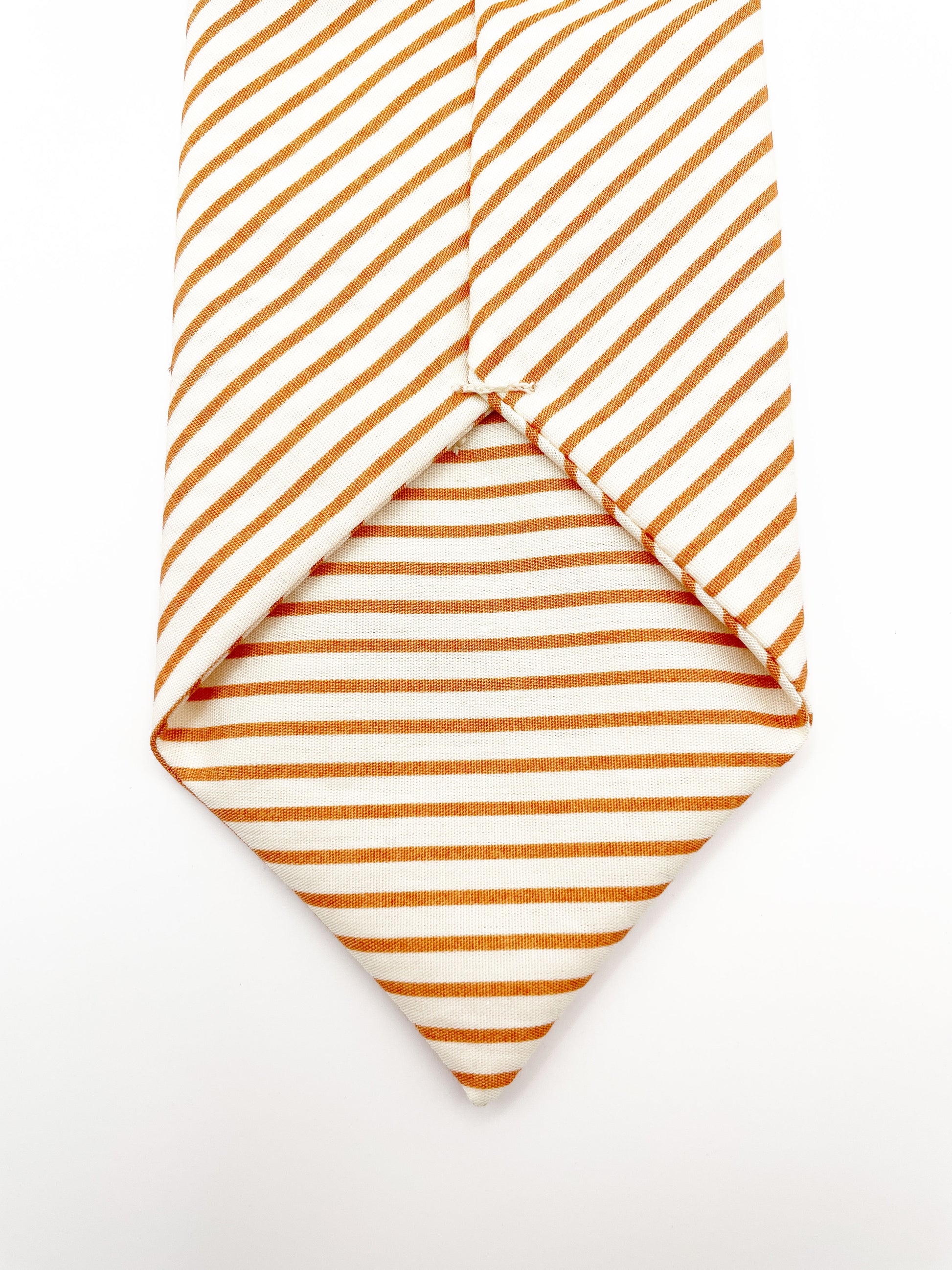 A handmade copper striped boho necktie.