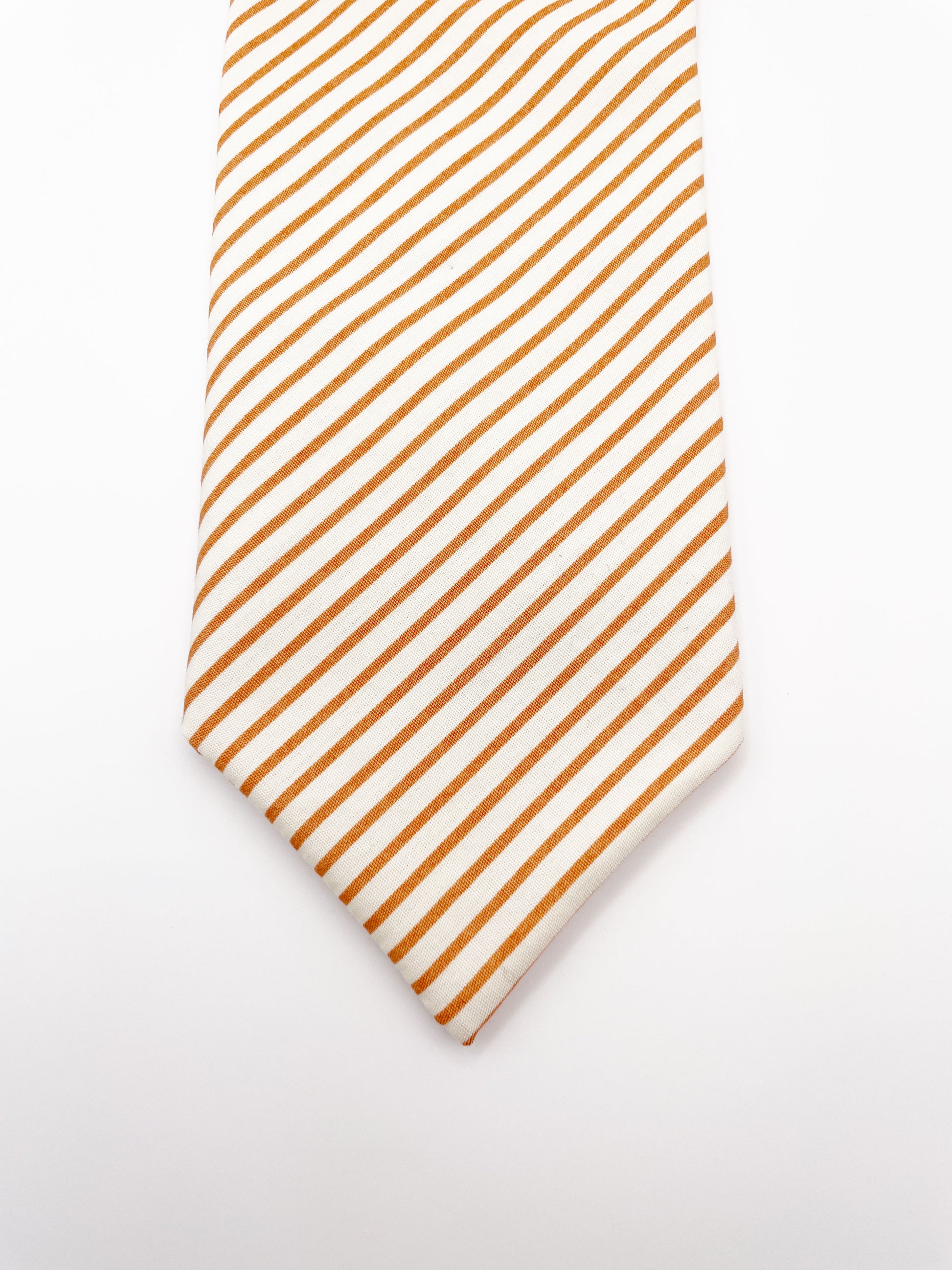 A handmade copper striped boho necktie.