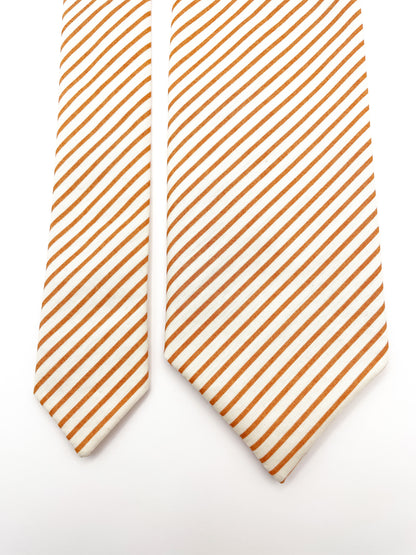 A handmade copper striped boho necktie.