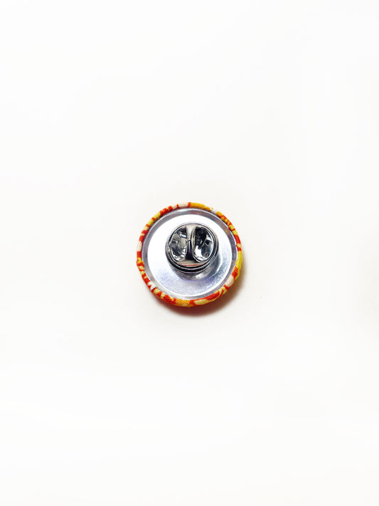 Handmade orange floral fabric covered lapel pin. Each pin has a clutch back closure.