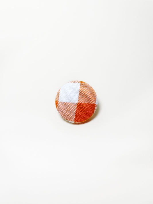 Handmade orange gingham plaid fabric covered lapel pin.