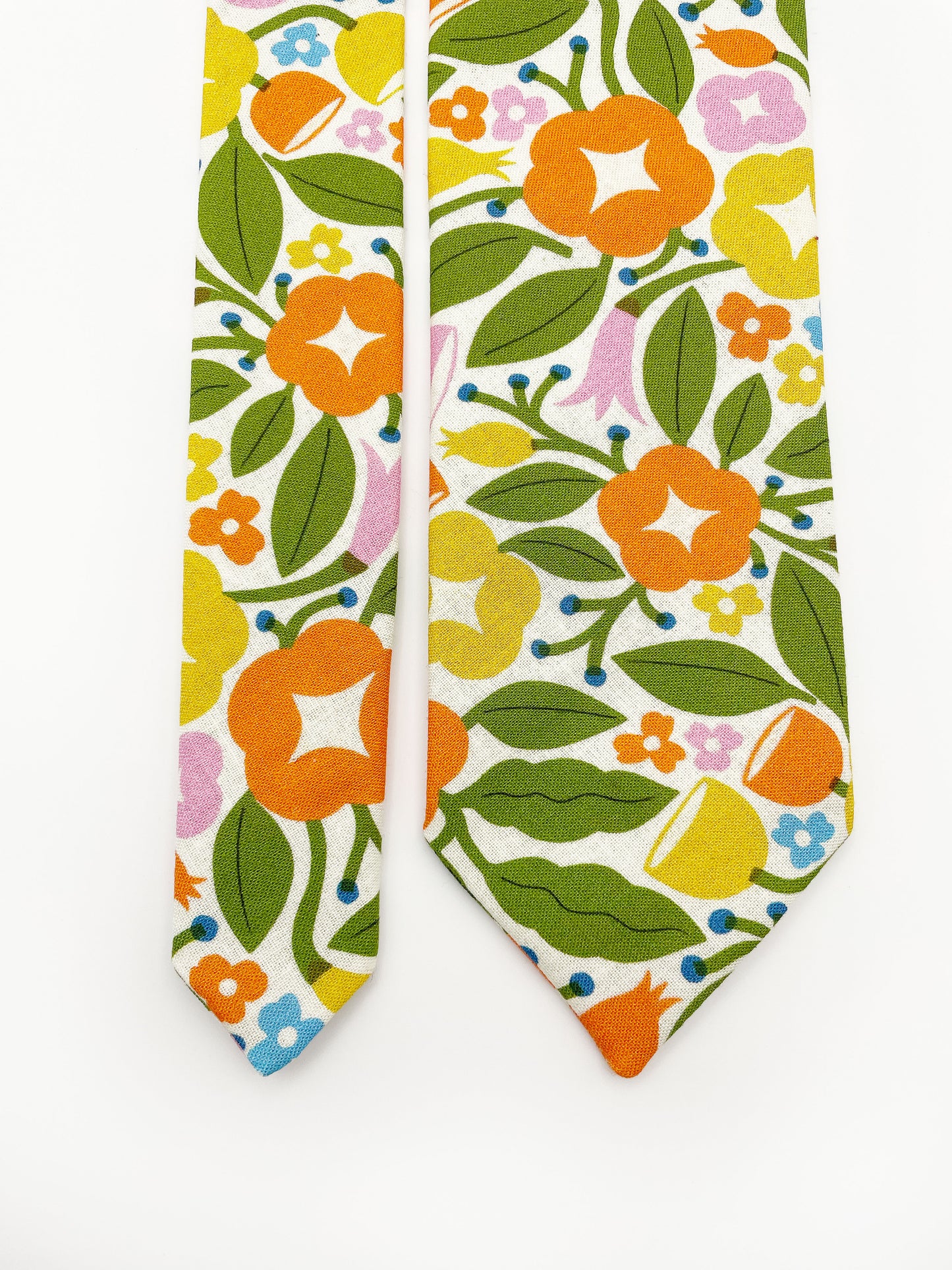 A vibrant necktie with bold yellow, orange, and pink flowers.