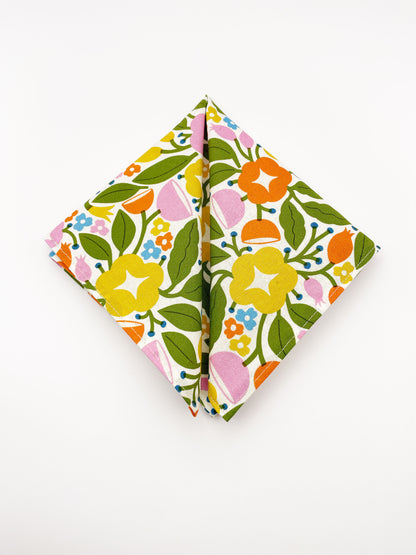 A vibrant pocket square with bold yellow, orange, and pink flowers.