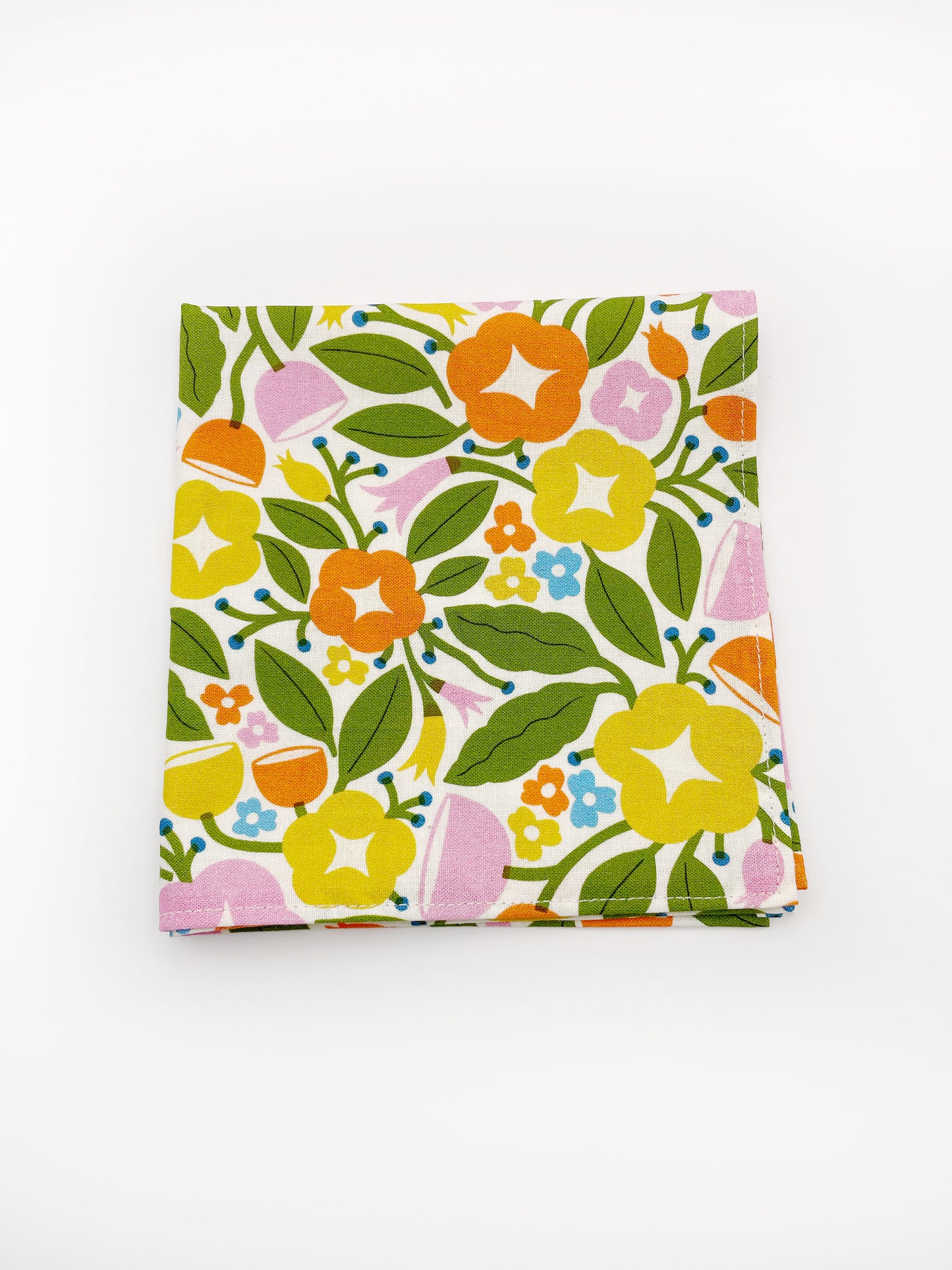 A vibrant pocket square with bold yellow, orange, and pink flowers.