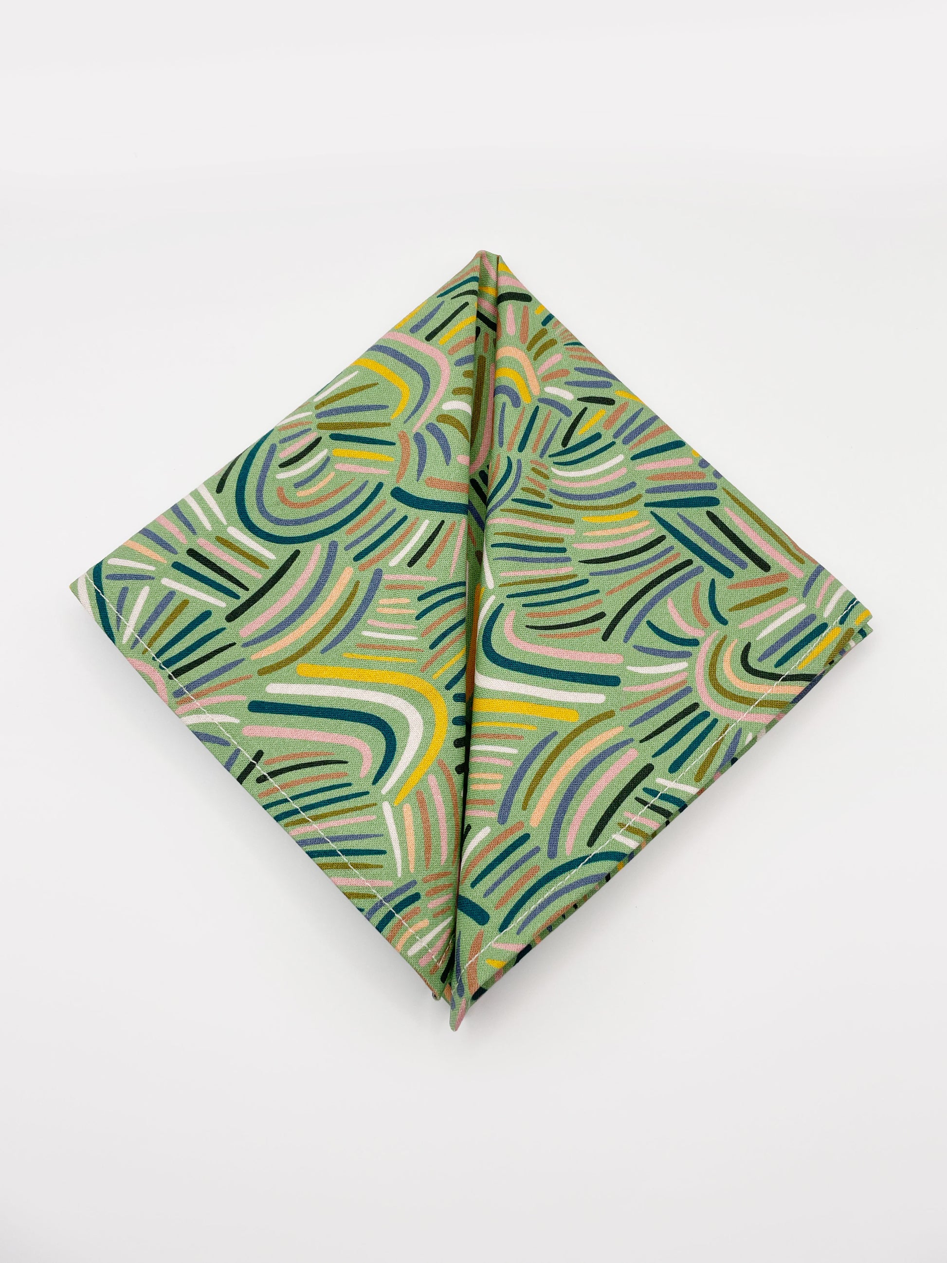 A pocket square made from high-quality cotton with an abstract design inspired by desert rain patterns.