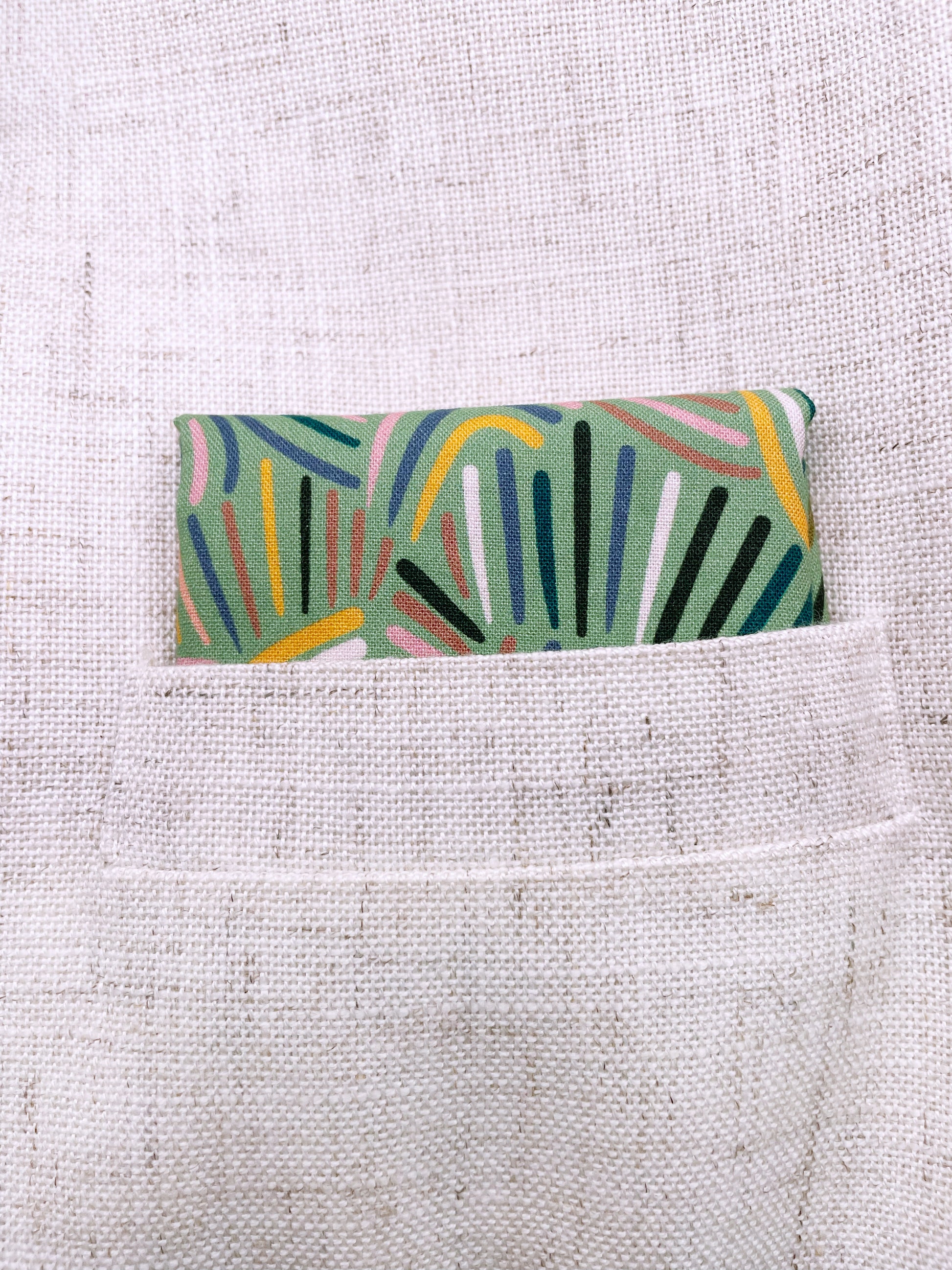 A pocket square made from high-quality cotton with an abstract design inspired by desert rain patterns.