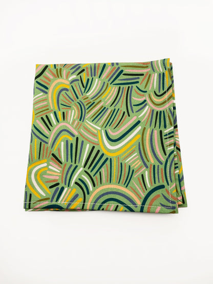 A pocket square made from high-quality cotton with an abstract design inspired by desert rain patterns.