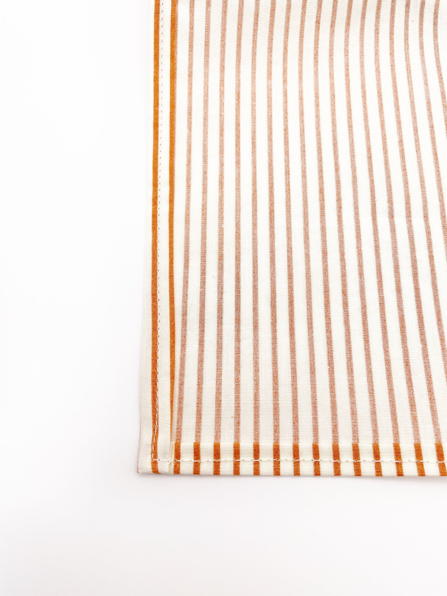 A handmade pocket square with copper stripes.