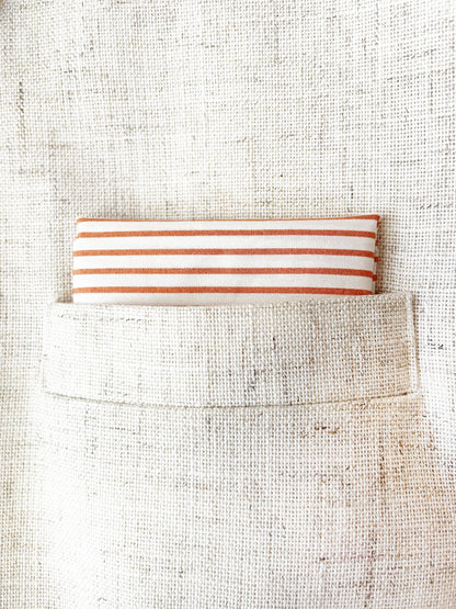 A handmade pocket square with copper stripes.